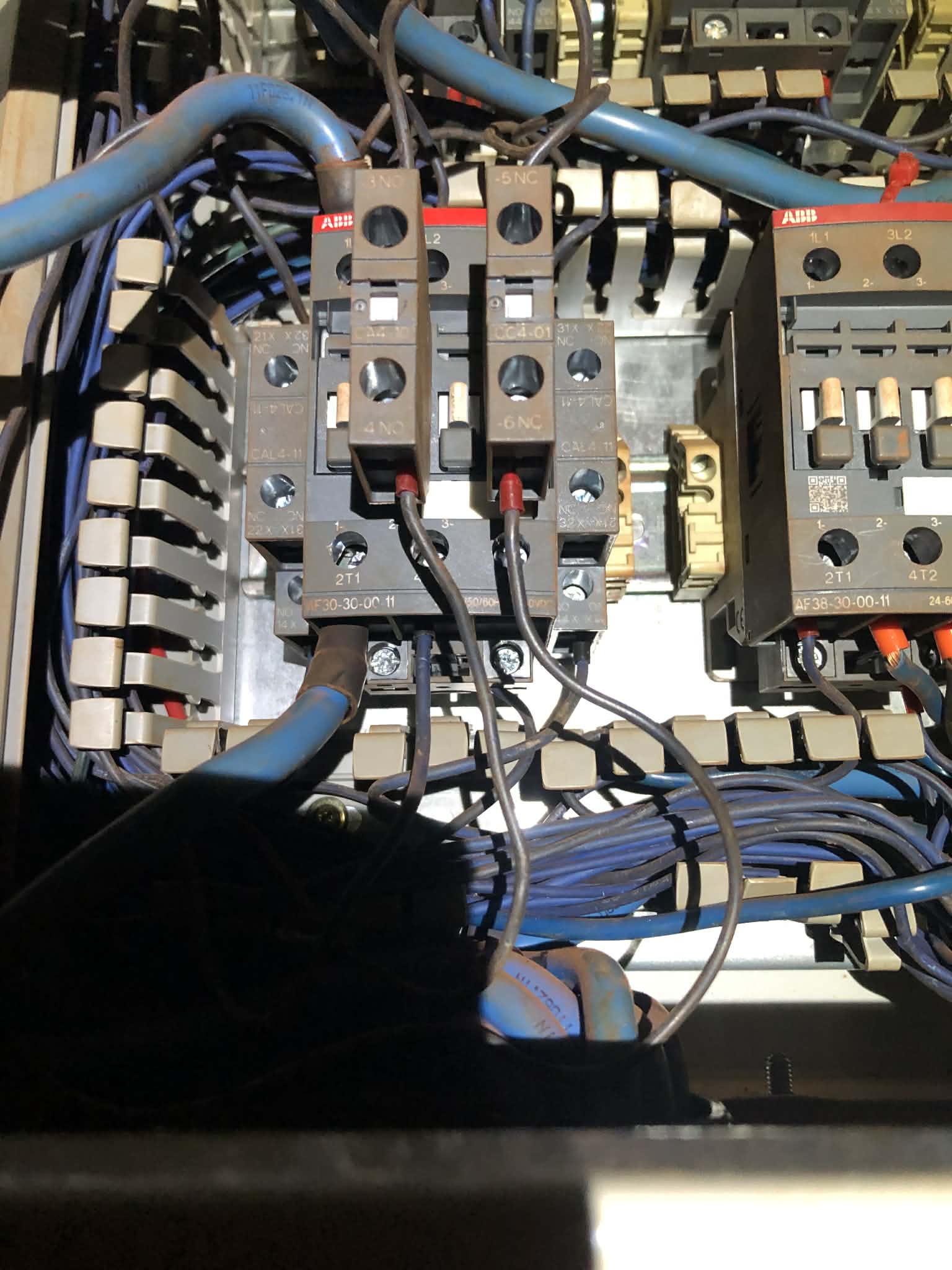 Detailed electrical contactors and wiring inside a control panel