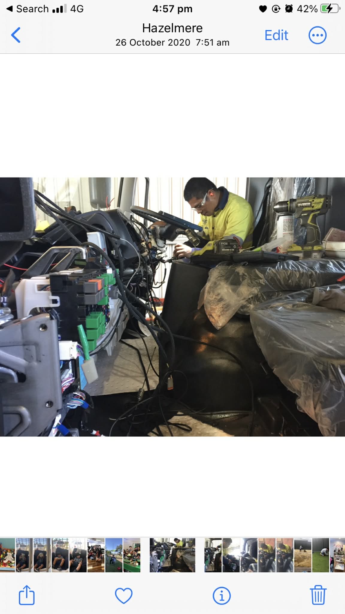 Technician performing electrical repairs inside a truck cabin