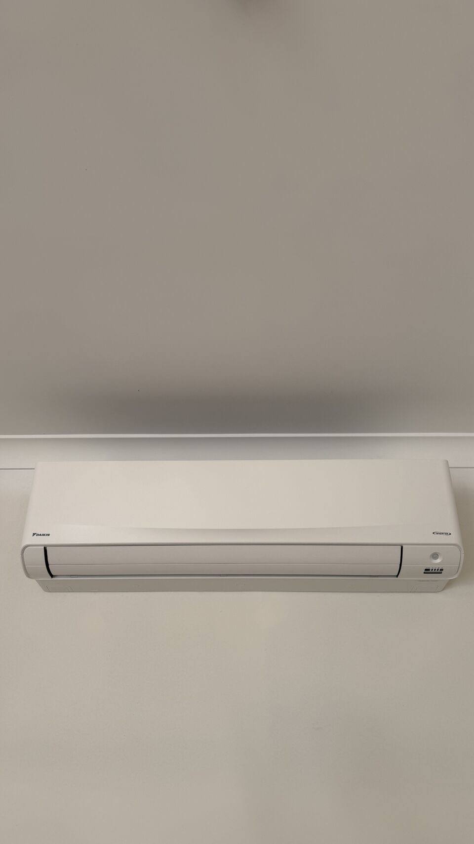 Split system indoor head fitted flush to a plastered wall