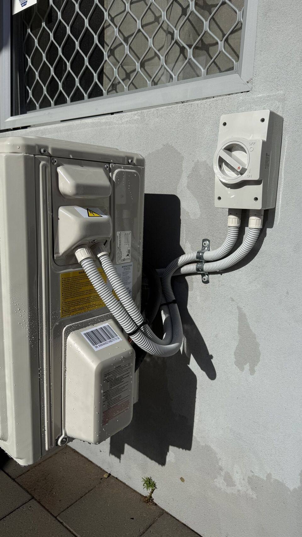 Condenser with isolator switch and flexible conduit connection